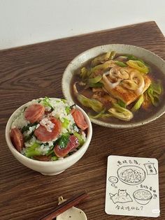 a bowl of soup with chopsticks next to it on top of a wooden table