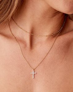 A combination you will love. Our 2 layered necklace comes with a ball station design layered with a simple chain featuring a cross pendant. Materials: 14K yellow, rose or white gold plated. Measurements: Beaded choker: 14"+2" extender; Cross necklace: 19" slider chain. Rose Gold Cross Pendant Necklace With Delicate Chain, Gold Cross Necklace Layered, Rose Gold Plated Cross Necklace, Gold Cross Layered Necklace, Rose Gold Plated Cross Pendant Necklace, Pretty Gold Necklaces, Layered Cross Necklace, White Gold Pendant Necklace, Dangle Necklaces