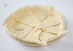 a bowl filled with pita chips on top of a white table