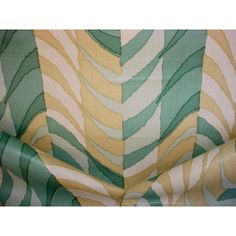 the fabric is green, yellow and white with wavy lines on it's sides