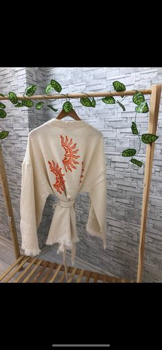 Beautiful handmade white short tassel kimono cardigan jacket with orange sun moon. ethnic boho kimono robe, designed with cotton fabric, flows as you move for comfortable wear. This is a lovely, good-quality kimono, with traditional breathable kimono sleeves. The belt ties around the waist. Great to wear around the house, on beaches, or to dress up with some jeans & a T-shirt, covering up on the beach with a swimsuit. The bird print is really elegant and beautiful. We love kimonos as they are so Traditional Kimono For Spring Beach Cover-up, White Spring Festival Kimono, Bohemian Cream Kimono For Spring, Folk Style Summer Beach Kimono, Cream Bohemian Kimono For Spring, Folk Style Cotton Kimono For Spring, Traditional Kimono For Beach Cover-up In Spring, Spring Kimono With Tassels And Long Sleeves, Traditional White Kimono For Summer