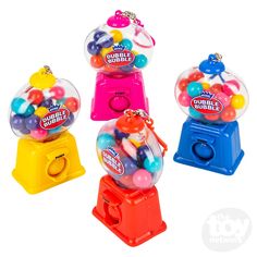 three gumball machines are shown in different colors and sizes, one is filled with candy