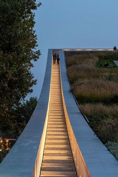 people are walking up and down the stairs at night, with their lights on in the distance