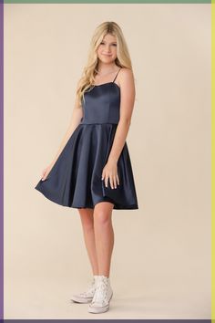 A true fit and flare dress featuring an all over, non-stretch, soft, satin fabric. This dress featured a sweetheart line line and adjustable straps for any tween or teen girl looking to wear a fun party dress. Has an easy zipper back and high waisted detailing. Works very well with any of our elasticated belts. Ginger is wearing a size 14 Height 5’5, Waist 27”, Bust 31 \ Teenage Dress Outfits, Banquet Dresses For Teens Long, Grade 8 Grad Dresses Navy Blue, Dance Dresses For Middle School, Teen Semi Formal Dresses, Navy Blue Dresses Short, Cute Prom Dresses For Teens, Promotion Dresses 8th Grade Graduation, Culmination Dresses