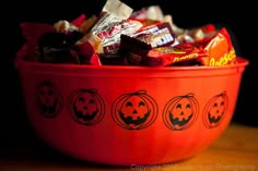 a red bowl filled with candy and candies