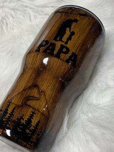 a wooden can with the words papa on it sitting on a white furnishing