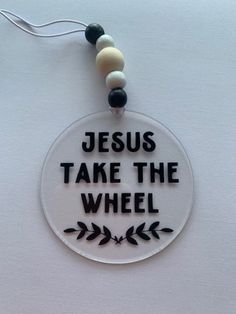 a necklace that says jesus take the wheel with beads hanging from it's side