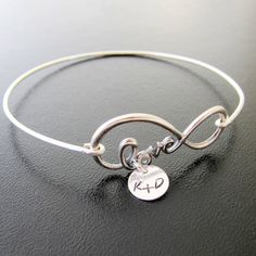 "Infinity Love Bracelet - Personalized Girlfriend Gift - Birthday Gift for Girlfriend - Anniversary Gift for Her Please mention initials in \"notes to seller\" during checkout and if you want a plus sign + or ampersand &... I can also stamp a single initial. A sterling silver infinity love symbol will be transformed into a personalized bracelet for girlfriend with couples initials (or single initial) stamped on a sterling silver disc, and corresponding hand formed sterling silver bangle band Name Charm Bracelet For Friendship, Personalized Friendship Charm Bracelet Gift, Personalized Charm Bracelet For Friendship On Valentine's Day, Inspirational Adjustable Bracelets For Birthday, Nickel Free Name Bracelet For Friendship And Mother's Day, Friendship Infinity Bracelets For Mother's Day, Nickel-free Name Bracelet For Mother's Day, Customizable Charm Bracelet For Valentine's Day Friendship, Inspirational Silver Bracelet For Birthday Gift