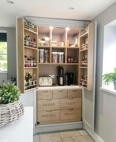 an organized pantry in the corner of a room with lots of drawers and boxes on it