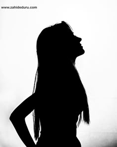 the silhouette of a woman with long hair