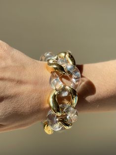 18k gold and crystal large link bracelet by Seaman Schepps. DESIGNER: Seaman Schepps MATERIAL: 18k Gold GEMSTONES: Crystal DIMENSIONS: Bracelet is 8 1/8" long end to end, approx. wearable length is 7-7.5", width 30mm. MARKED/TESTED: 1959, Seaman Schepps, Shell mark, 750. WEIGHT: 113.1 grams. CONDITION: Previously Owned, Excellent Condition. Round Lucite Jewelry For Parties, Clear Bracelet Jewelry For Party, Luxury Chain Link Party Bracelets, Luxury Chain Link Bracelets For Parties, Modern Chain Link Party Bracelets, Modern Clear Bracelet Jewelry, Modern Chunky Chain Bracelets For Party, Elegant Clear Bangle Jewelry, Clear Lucite Party Jewelry