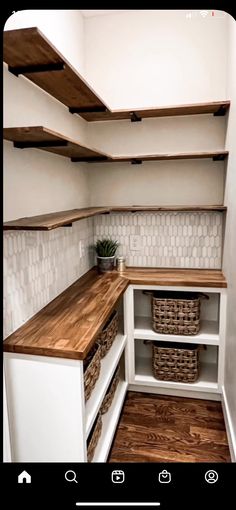 an empty pantry with wooden shelves and baskets