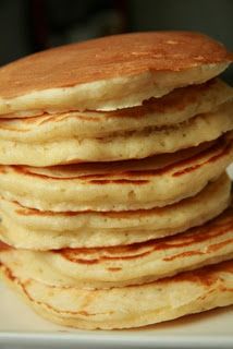 a stack of pancakes sitting on top of a white plate