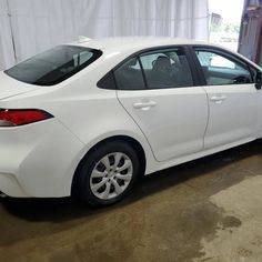 a white car is parked in a garage