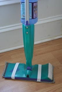 a blue and white dust mop on the floor