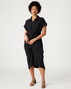 The TORI dress has a rolled collar and cuffed short sleeves, with an adjustable gathered tie-front waist and a high-low hem. The dress is finished with a lightweight woven crepe fabric, giving it a polished look. Tie-front midi shirt dress Button-up closure Elastic in back Length: 48" 100% polyester Hand wash Trea is 5ft 10in and is wearing a size 12 Maelyn is 5ft 11.5in and is wearing a size 4 Imported Fitted Rayon Shirt Dress With Short Sleeves, Chic Short Sleeve Viscose Shirt Dress, Fitted Short Sleeve Rayon Shirt Dress, Short Sleeve Midi Dress With Tie Fastening For Daywear, Workwear Dresses With Gathered Waist And Short Sleeves, Rayon Midi Dress With Short Sleeves For Daywear, Short Sleeve Rayon Midi Dress For Daywear, Short Sleeve Dresses With Gathered Waist For Work, Short Sleeve Shirt Dress With Tie Waist For Daywear