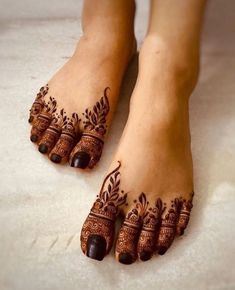 feet with henna tattoos on them