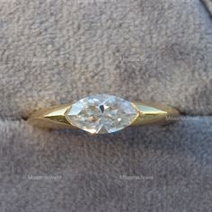 a gold ring with a white diamond in it