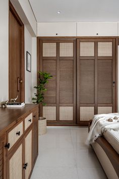 a bed sitting in a bedroom next to a wooden dresser and window covered with blinds