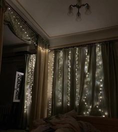 the lights are shining on the curtains in the bedroom