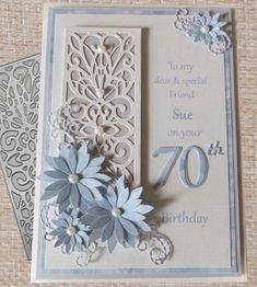 a birthday card with paper flowers and the number seventy on it's front side