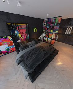 a large bed sitting in the middle of a room next to a painting on the wall