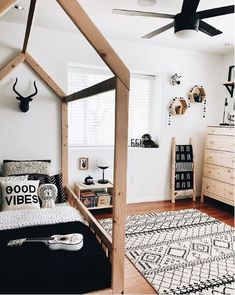 a bedroom with white walls and black accents