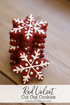 red velvet cut out cookies decorated with white snowflakes on a wooden board and text overlay reads red velvet cut out cookies