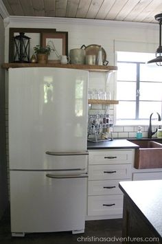 a white refrigerator freezer sitting inside of a kitchen