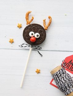 an oreo cookie on a stick decorated like a reindeer