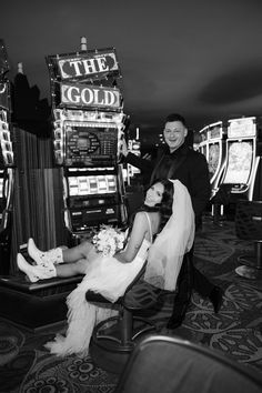 a man and woman sitting next to each other in front of slot machines