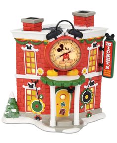 a mickey mouse house clock on display in front of a white background