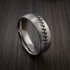 a baseball ring with black stitches engraved on it