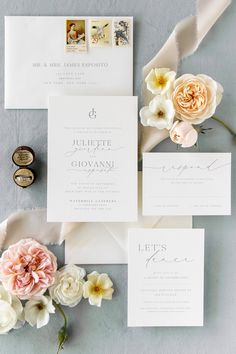 the wedding stationery is laid out on top of each other with flowers and ribbons