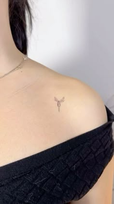 a woman with a small tattoo on her chest