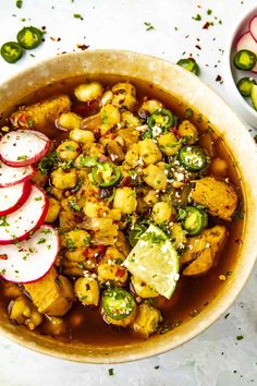 a bowl filled with stew and vegetables next to sliced radishes on the side