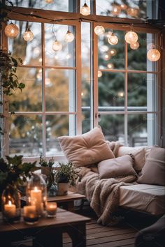 a living room filled with furniture and lots of lights hanging from the window sill