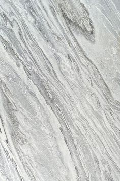 a white marble textured surface with grey veiners and lines on the edges, as seen from above