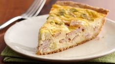 a slice of ham and cheese quiche on a plate