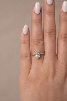 a woman's hand with a diamond ring on it