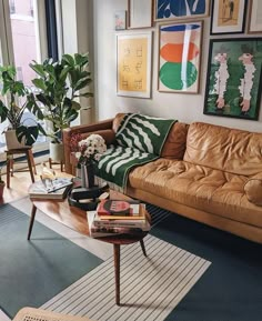 a living room filled with furniture and pictures on the wall