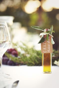 a bottle of olive oil sitting on top of a table