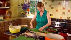 a woman is preparing food in the kitchen