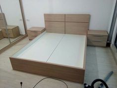 a bedroom with a bed, dressers and mirror in it's center area