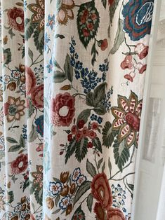 the curtains are covered with floral fabric