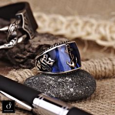 "Unique high quality handmade silver ring with Anchor Symbol design. Matchless sailor signet ring. Has 1 year guaranty for the production mistakes. No Stone 3d Enamel Work Material: Sterling Silver 925k Plated: Rodium Plated Weight: 13.00gr CUSTOMIZATION: I can make the same ring with another symbol instead of Anchor. If you interesting custom made symbols for you please contact before your order. I can make the same ring of 10K GOLD ,14K GOLD, 18K GOLD or 22K GOLD at an EXTRA COST. Please conta Gift Rings In Metal With Polished Finish, Symbolic Handmade Stainless Steel Rings, Handmade Symbolic Stainless Steel Rings, Handmade Vintage Stainless Steel Rings, Handmade Stainless Steel Rings For Anniversary, Handmade Stainless Steel Rings For Gifts, Anchor Symbol, Navy Rings, Sea Rings