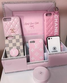 a pink case filled with lots of different types of cellphones and cases next to each other