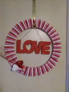 a valentine's day wreath with the word love made out of strips of paper