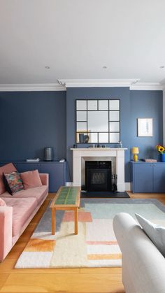 a living room filled with furniture and a fire place in the middle of a room