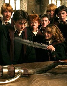 a group of young people standing next to each other in front of a harry potter's wand